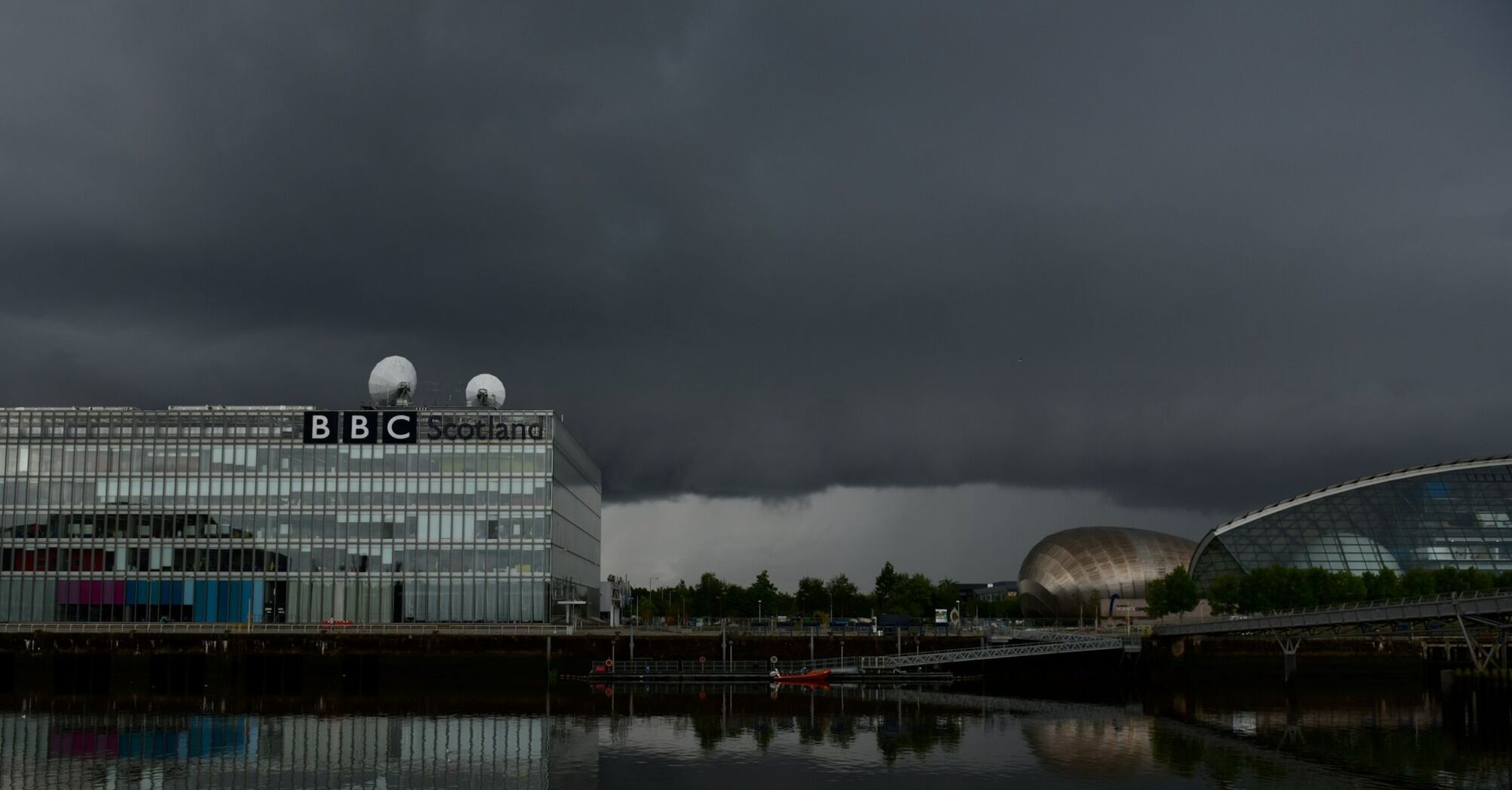 Dark storm clouds loom over the BBC Scotland building