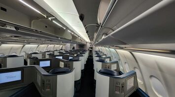 Delta Air Lines business class cabin with individual entertainment screens