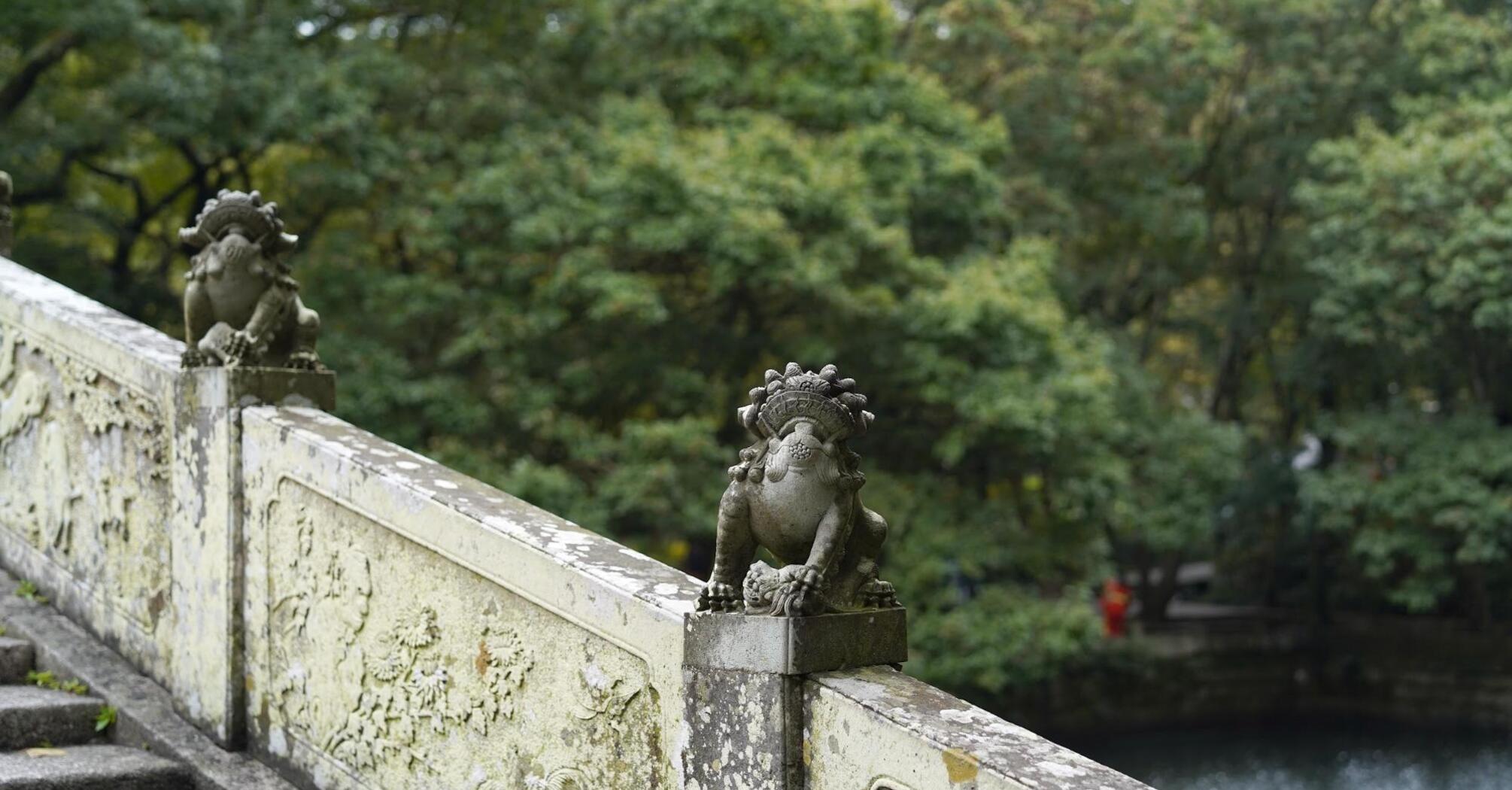 Guardian sculpture at the entrance of a serene sculpture park