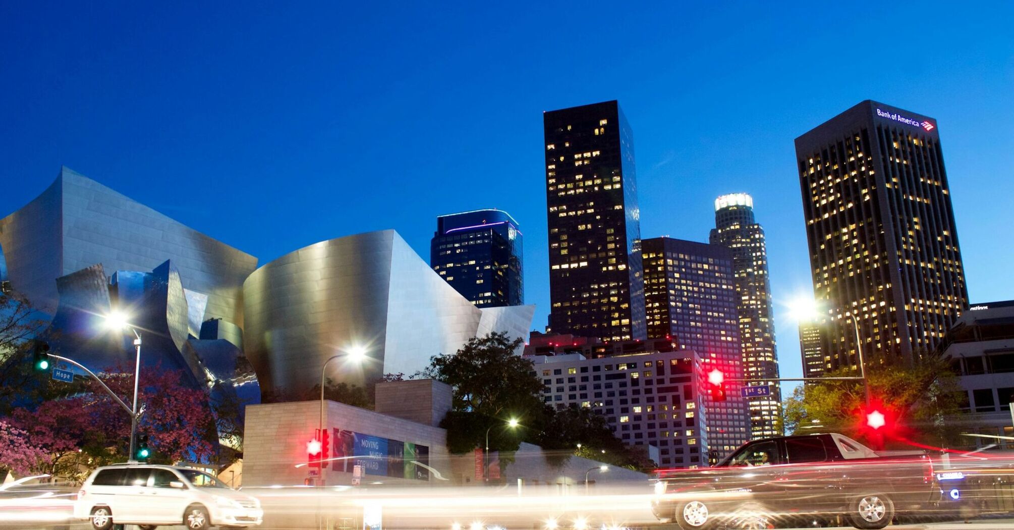 Downtown Los Angeles skyline at dusk with traffic lights and modern architecture