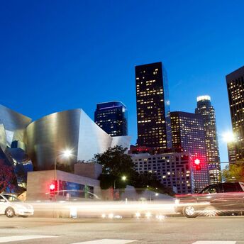 Downtown Los Angeles skyline at dusk with traffic lights and modern architecture