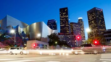 Downtown Los Angeles skyline at dusk with traffic lights and modern architecture