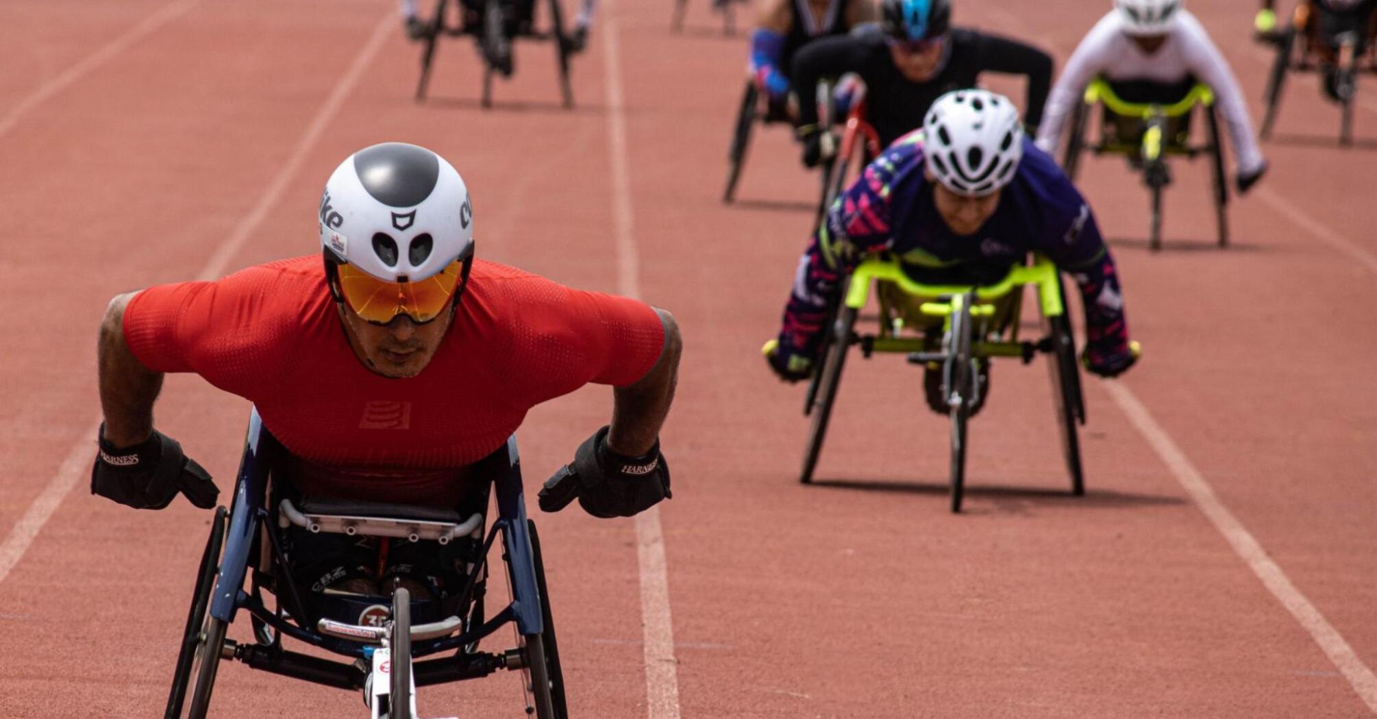 Athletes compete in a wheelchair race on the track