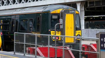 A stationary train at a platform inside a covered railway station
