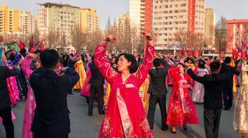 Traditional dance performance in North Korea with participants wearing colorful hanbok