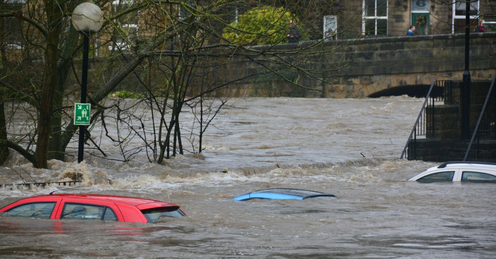 Flooded street with submerged cars after heavy rainfall