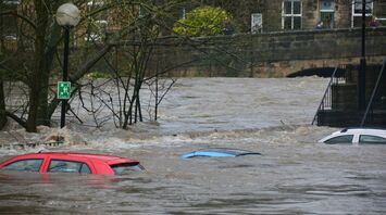 Flooded street with submerged cars after heavy rainfall
