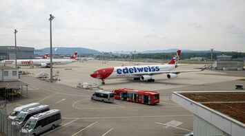 white and red passenger plane on airport during daytime