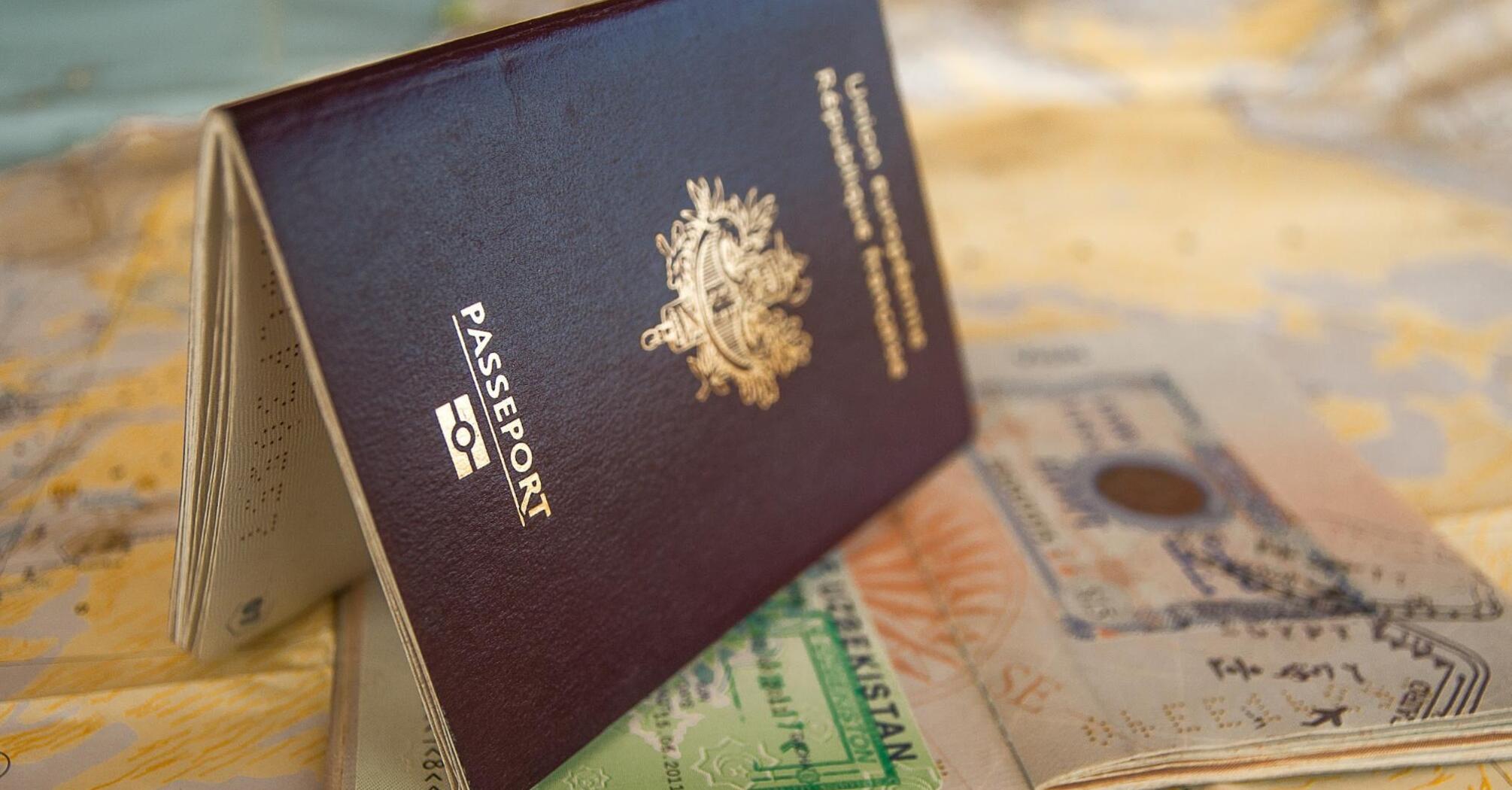 Passport with visa stamps on a world map