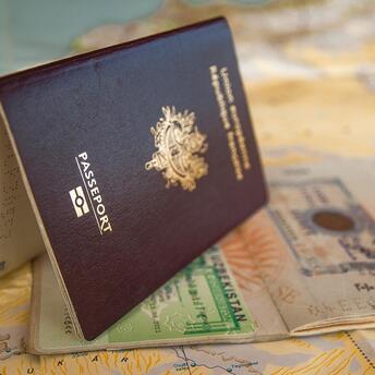 Passport with visa stamps on a world map