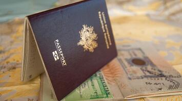 Passport with visa stamps on a world map