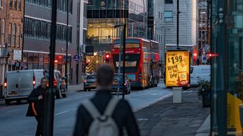 A busy street in Manchester with Stagecoach bus, pedestrians, and city buildings at dusk