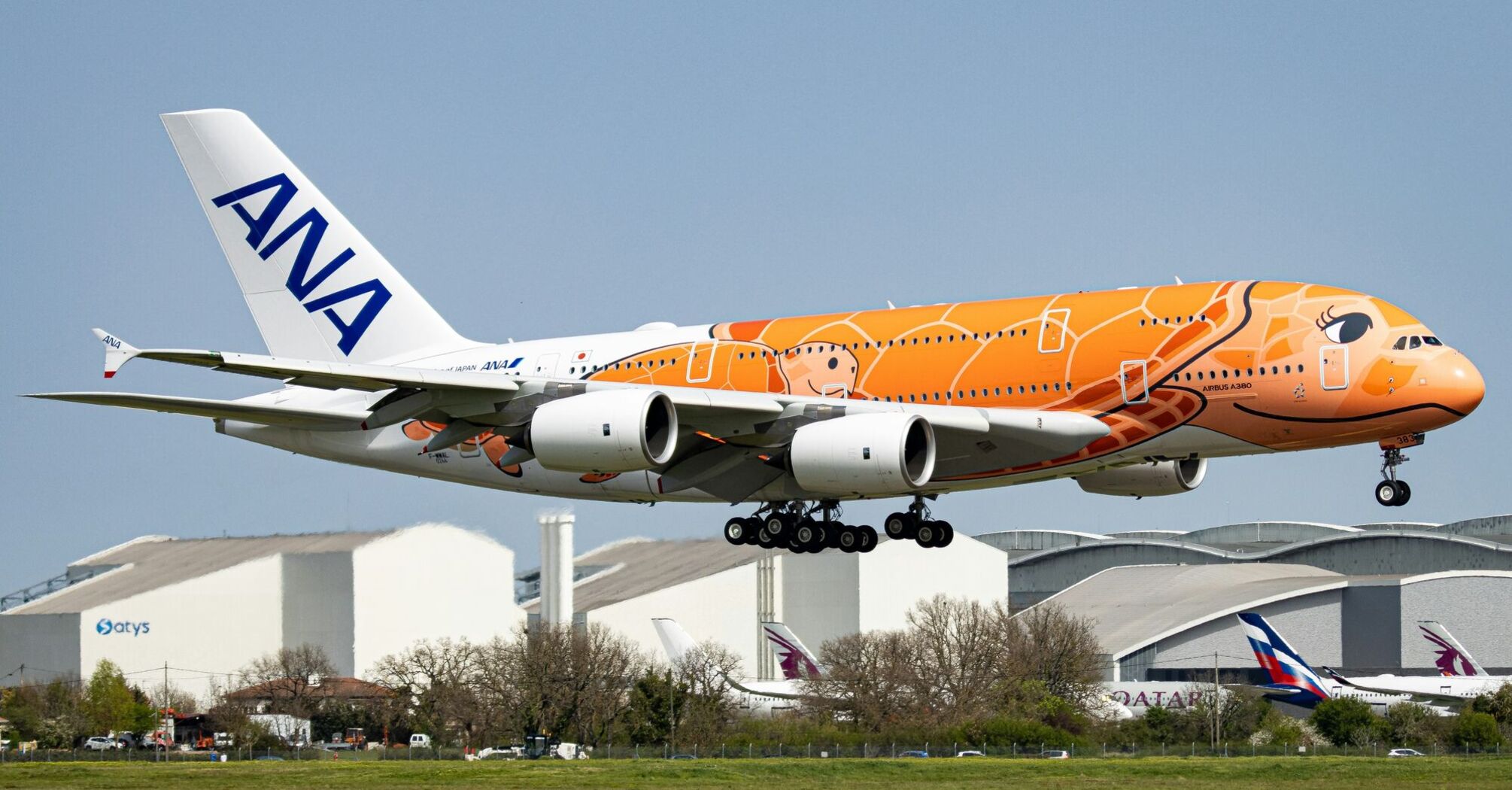 orange and white passenger plane on airport during daytime