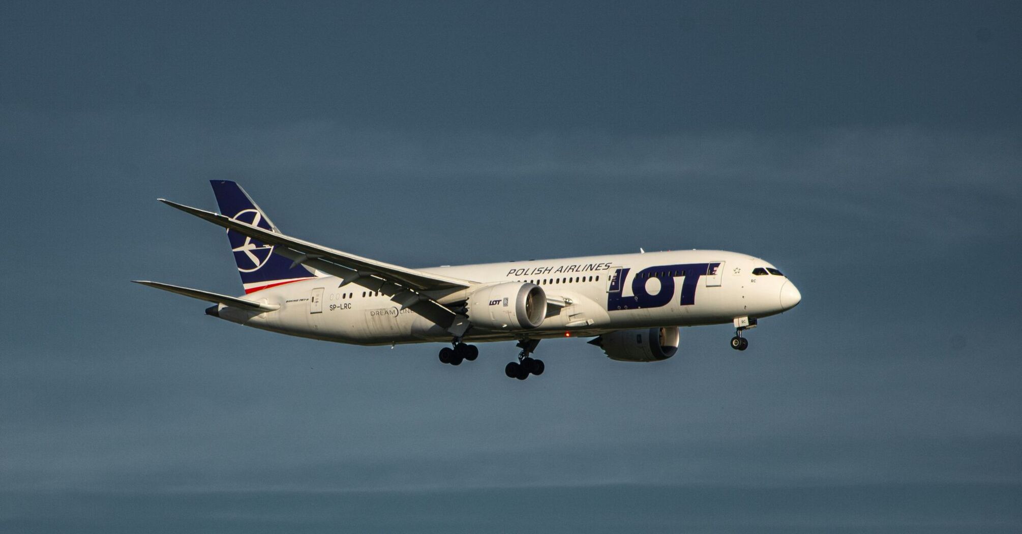 a large jetliner flying through a blue sky