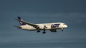 a large jetliner flying through a blue sky
