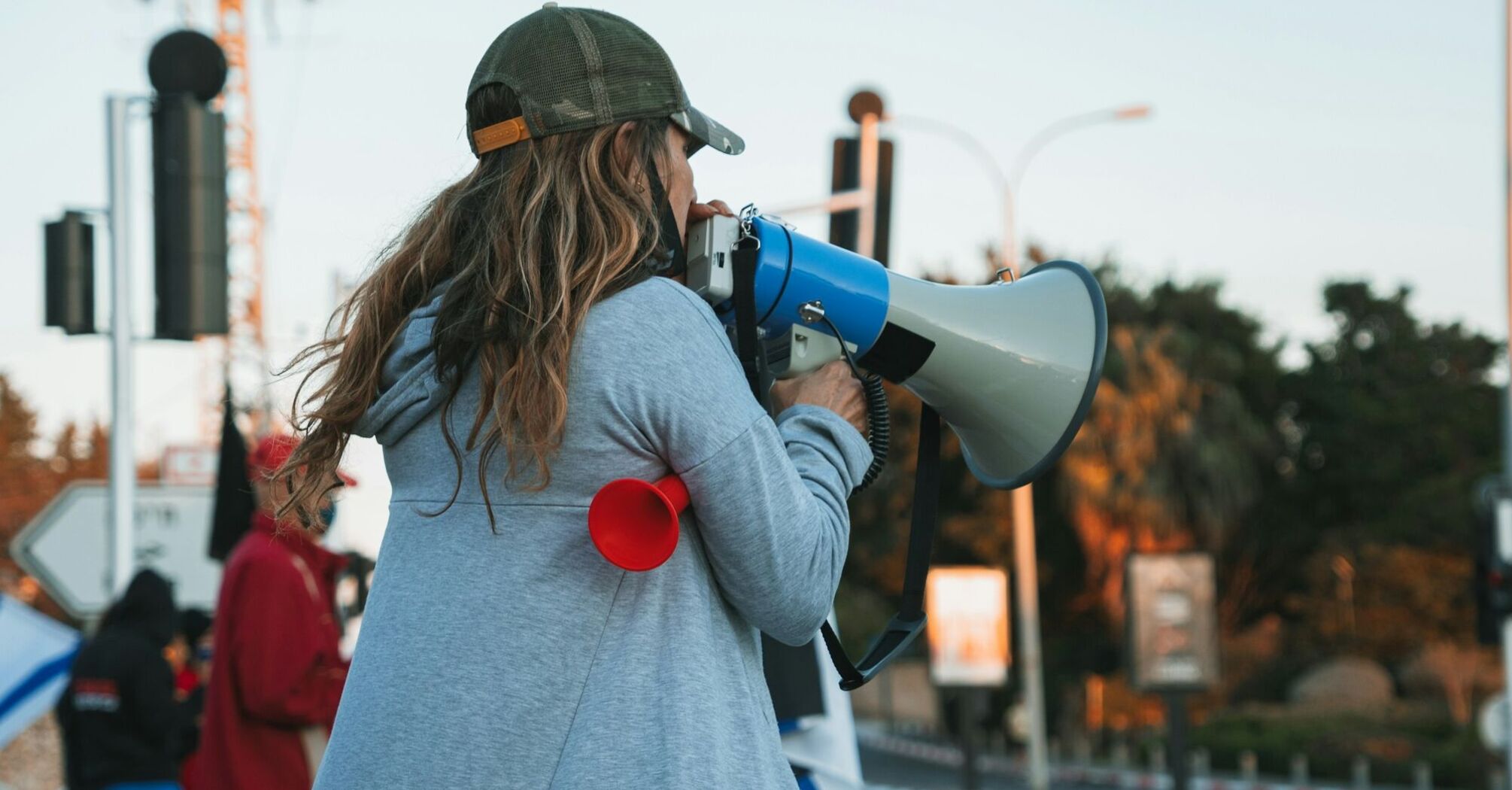 Protester speaking through a megaphone at a street demonstration