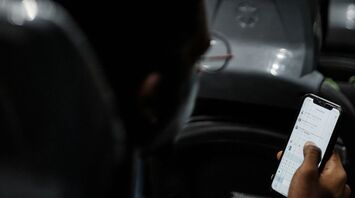 Passenger using a smartphone while riding on a bus