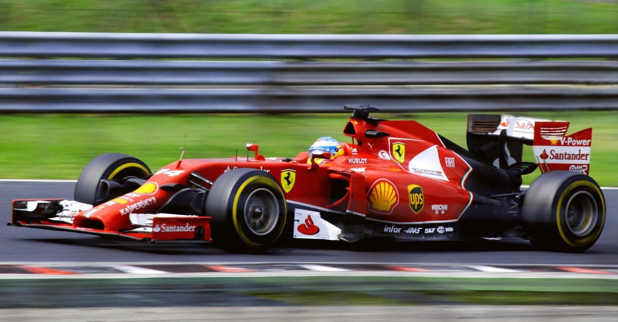 A red Formula One Ferrari racing car on the track