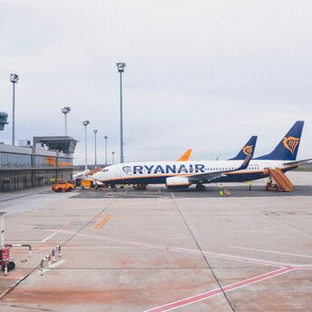 white and blue ryanar airliner on airport