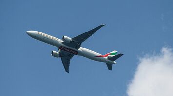 a large jetliner flying through a blue sky