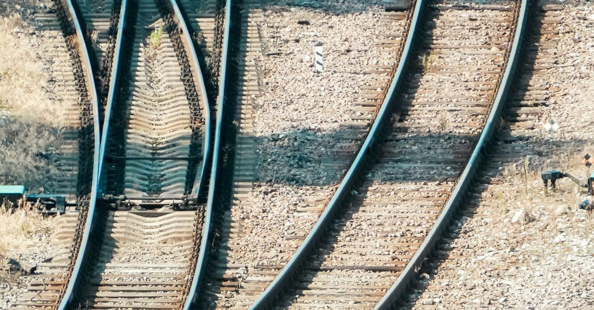 Multiple railway tracks converging, symbolizing route complexity and transport options