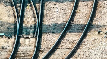 Multiple railway tracks converging, symbolizing route complexity and transport options