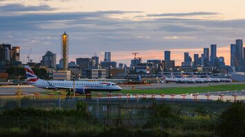 View of London City Airport at sunset with British Airways planes on the runway