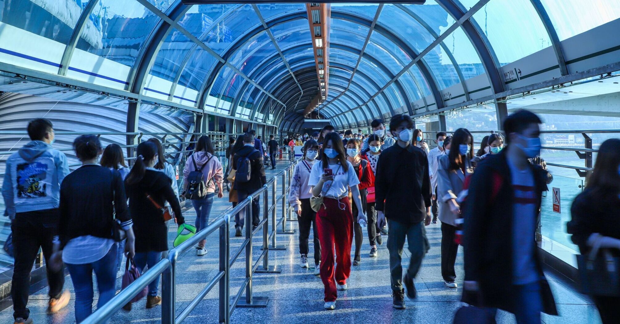 People walking through a busy airport terminal