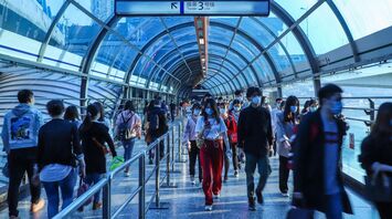 People walking through a busy airport terminal
