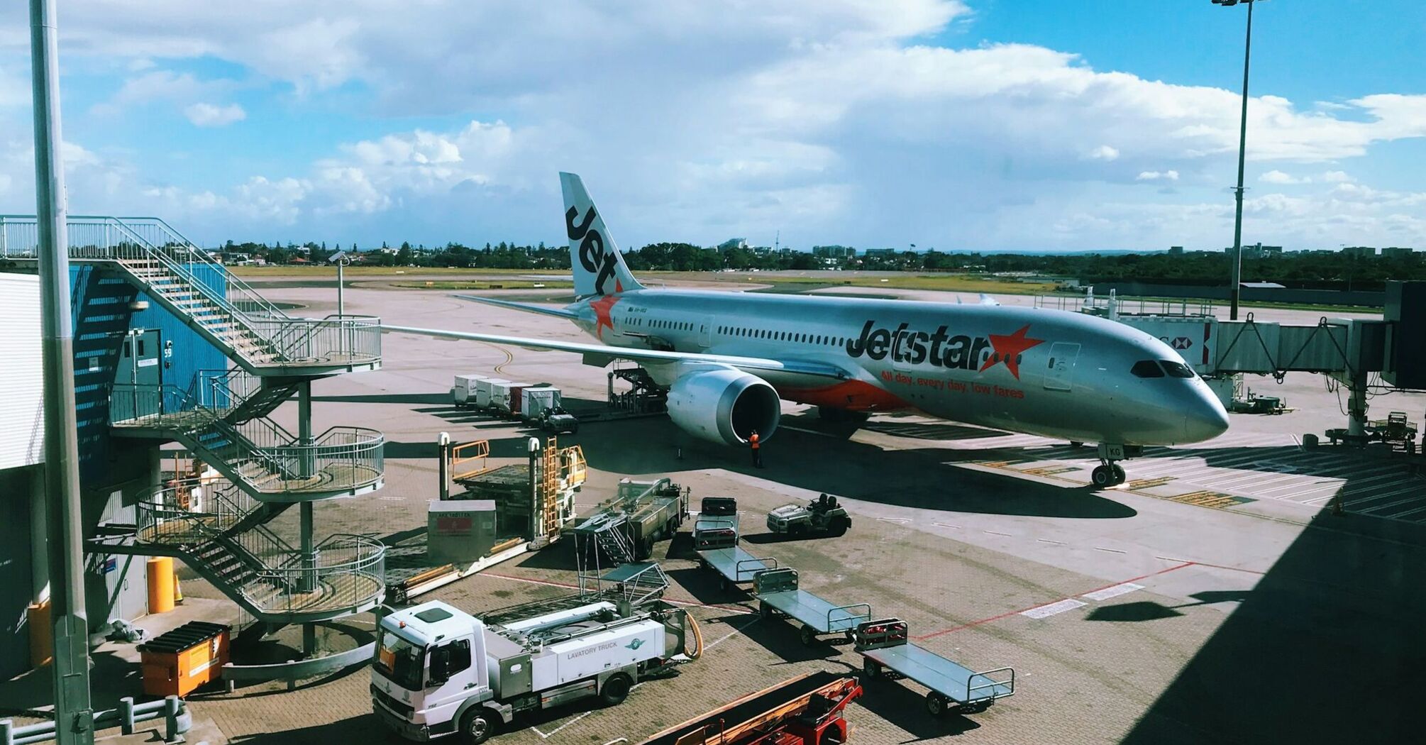 Jetstar airplane parked at airport gate