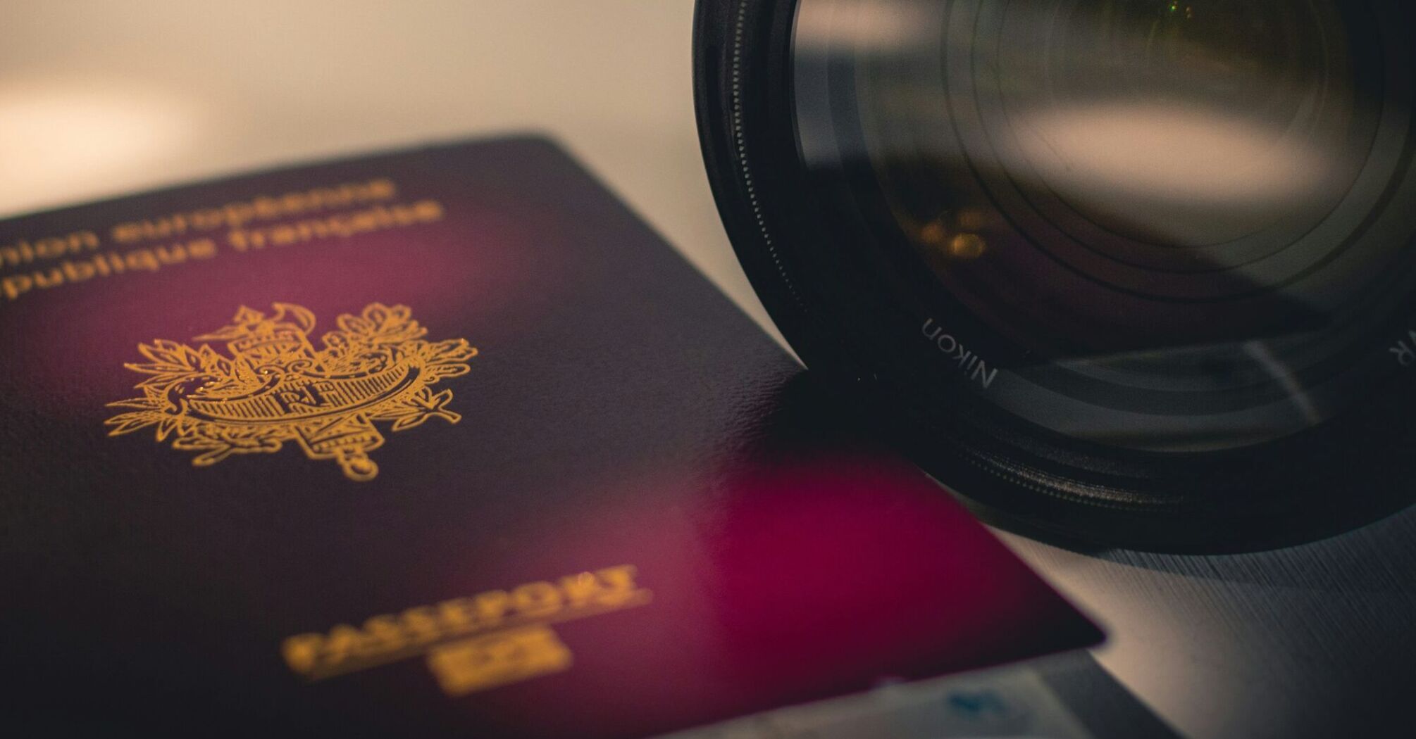 French passport next to a camera lens