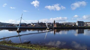 Reflections of the Derry Skyline on the River Foyle on a calm day.