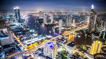 Night view of Bangkok cityscape with illuminated skyscrapers and Chao Phraya River