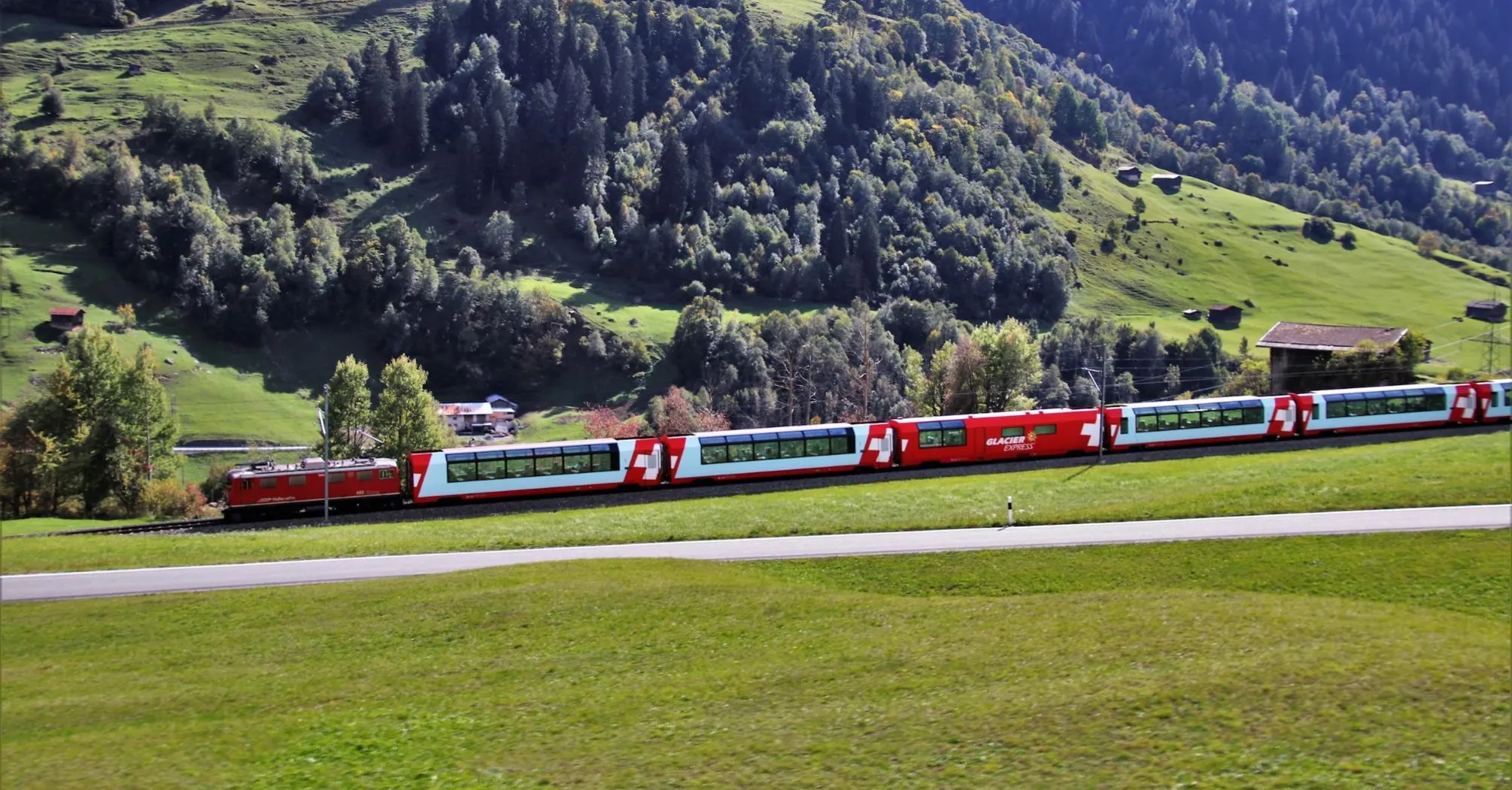 Scenic Swiss train passing through a lush green valley