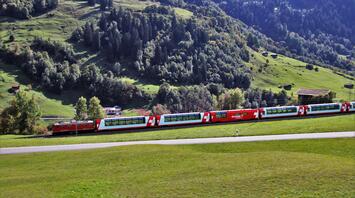 Scenic Swiss train passing through a lush green valley