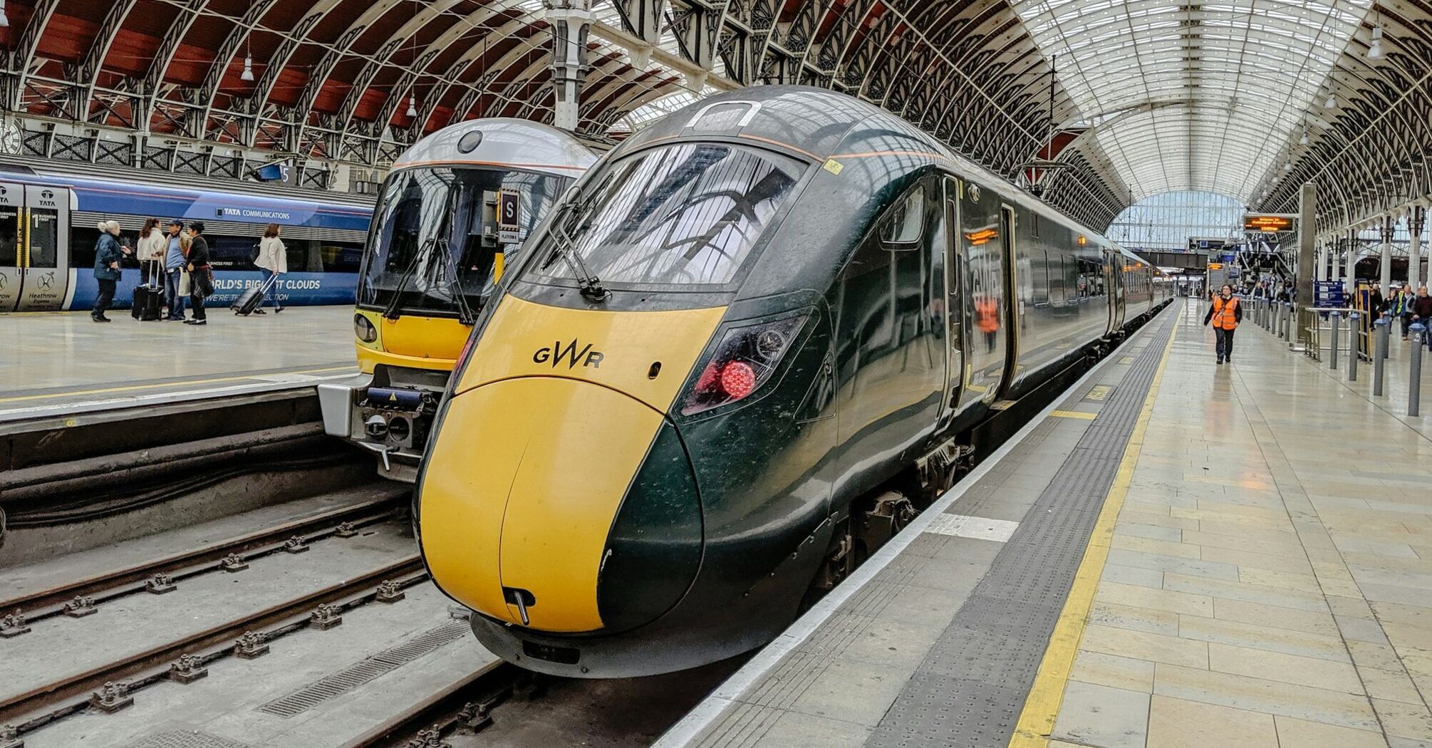 Trains at London Paddington station with passengers on the platform