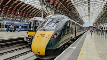 Trains at London Paddington station with passengers on the platform