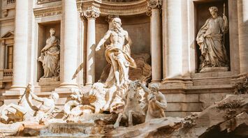 Close-up view of the Trevi Fountain in Rome featuring statues of mythological figures and cascading water