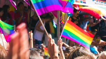 People waving rainbow flags at a pride parade