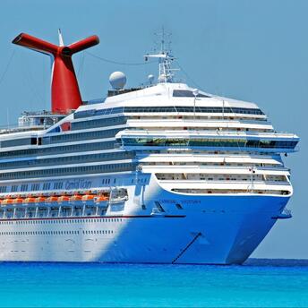 A Carnival Cruise Line ship sailing in clear blue waters