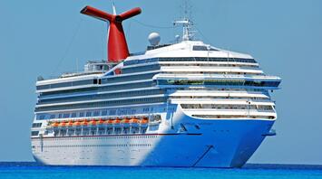 A Carnival Cruise Line ship sailing in clear blue waters