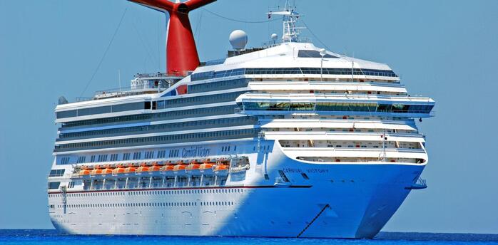 A Carnival Cruise Line ship sailing in clear blue waters