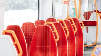 Interior of a SWR train with bright orange and red seats