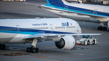 Two ANA (All Nippon Airways) airplanes on the tarmac at an airport