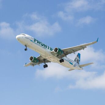 a large jetliner flying through a blue sky
