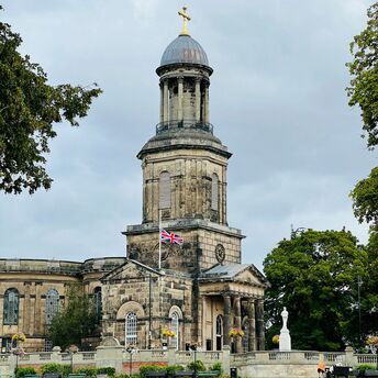 A historic stone building in Shrewsbury with a domed tower