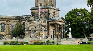 A historic stone building in Shrewsbury with a domed tower