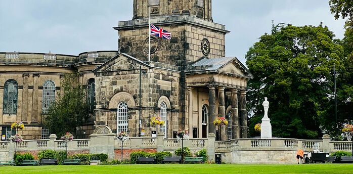 A historic stone building in Shrewsbury with a domed tower