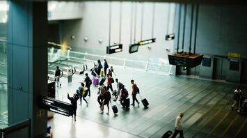 Passengers walking through a modern airport terminal