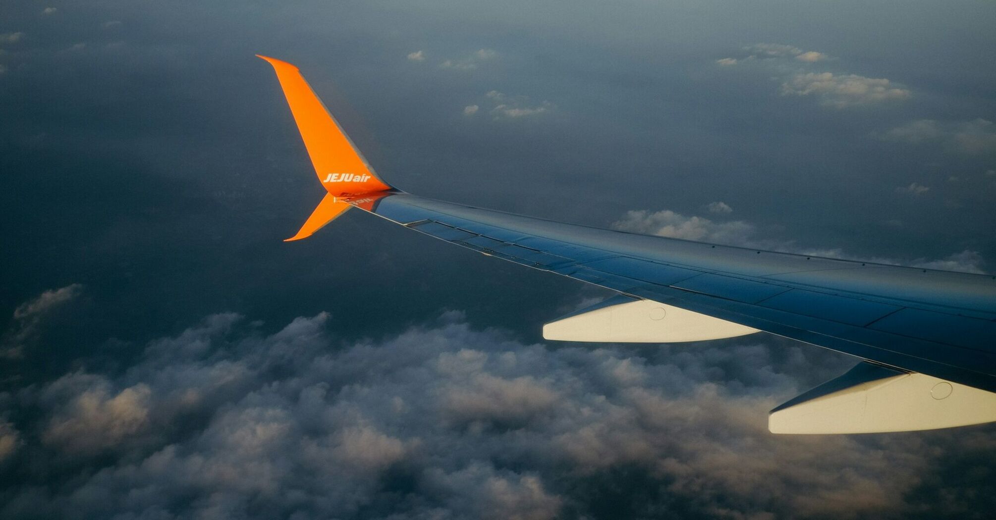 Jeju Air plane flying above the clouds